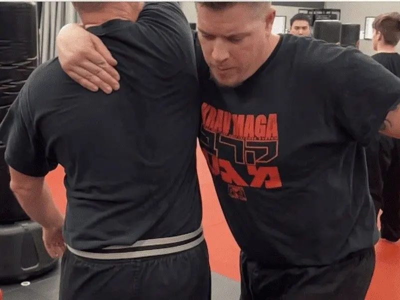 self defense class with instructor and student practicing drills